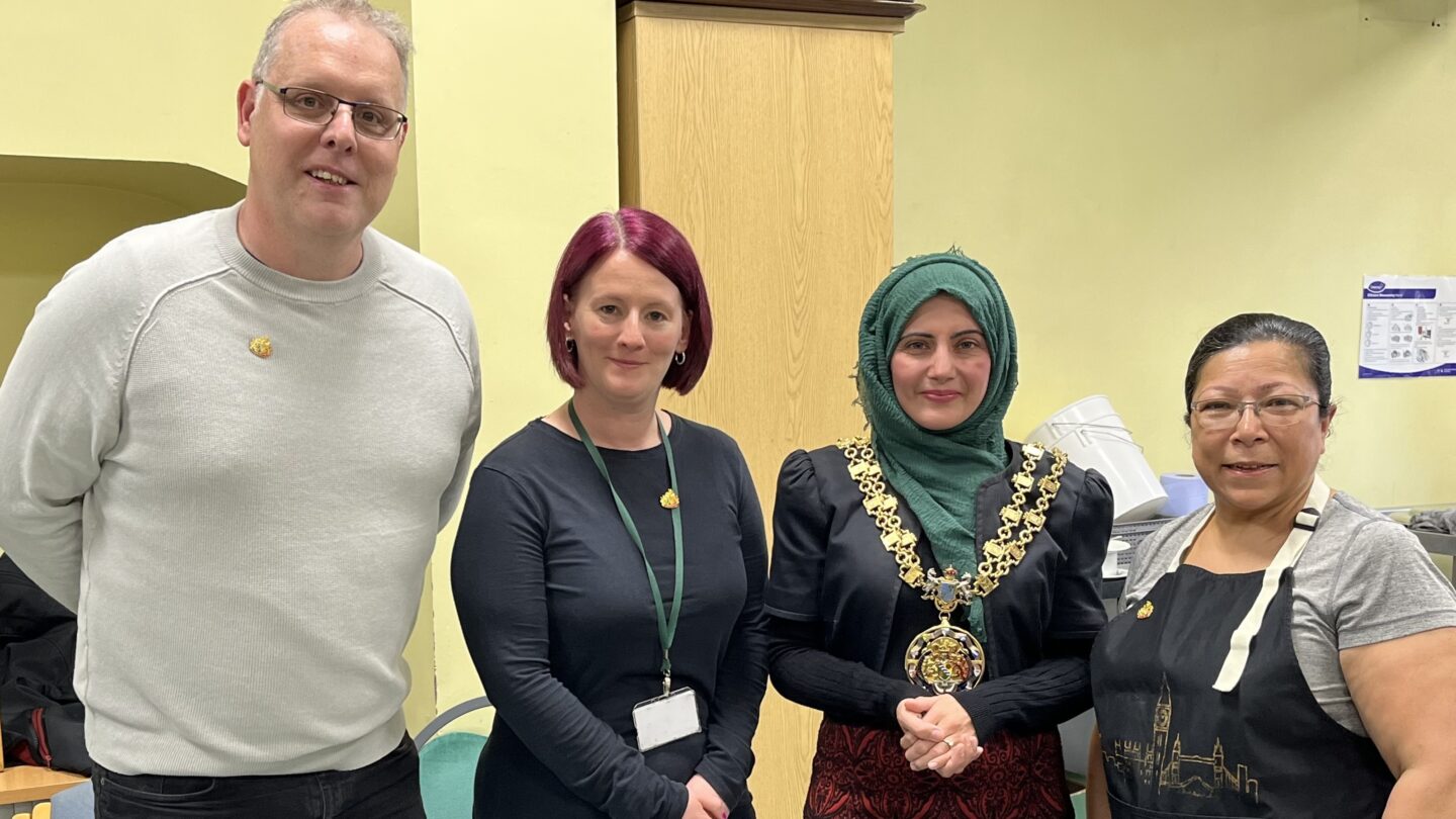 Mayor of Tameside standing alongside three recipients of the Mayoral pin badge