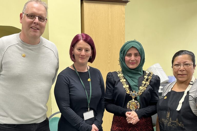 Mayor of Tameside standing alongside three recipients of the Mayoral pin badge