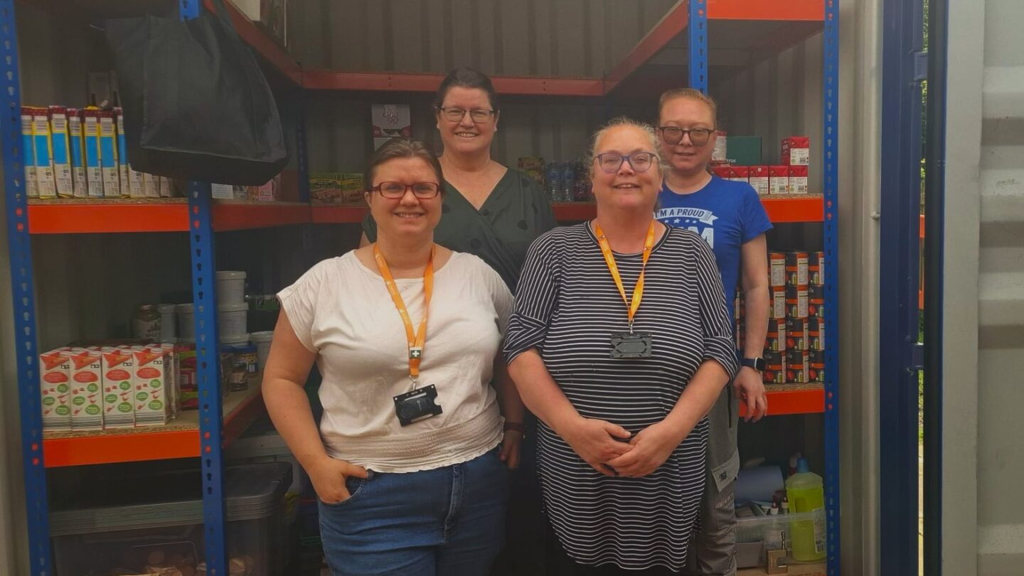 Four Quids In volunteers standing in front of one of their affordable food clubs