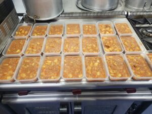Containers of food on a catering kitchen counter