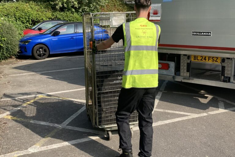 GXO staff pushing a trolley