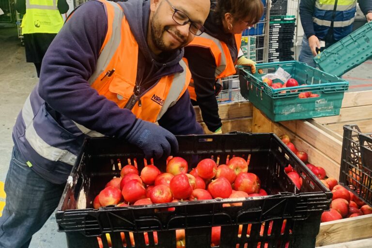 N Brown volunteer loading apples at FareShare Greater Manchester