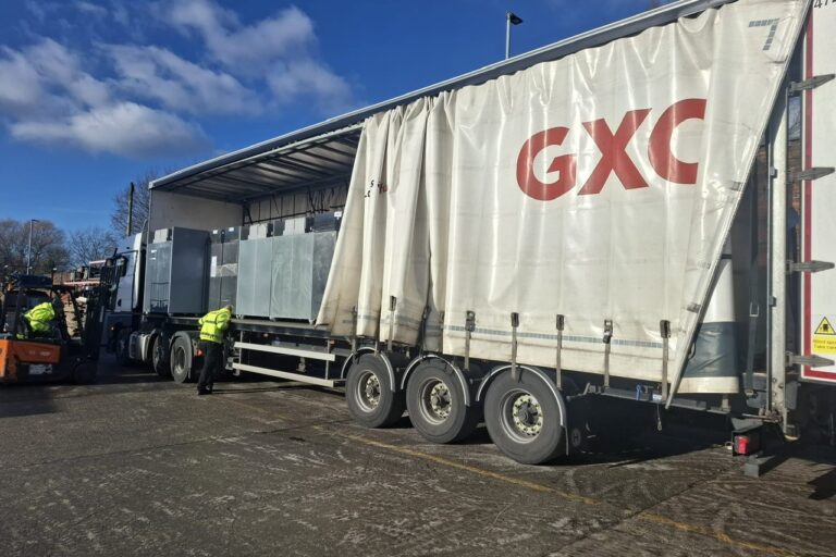 large GXO lorry with side curtain pulled back to show fridges on board