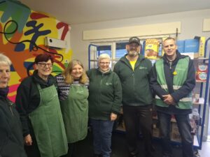 Image shows volunteers from Cedar Park Pantry smiling for the camera
