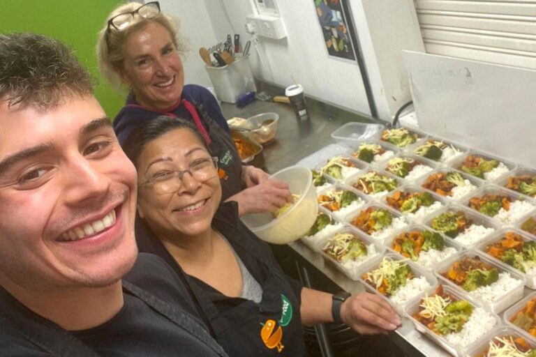 people smiling with some boxed up ready meals